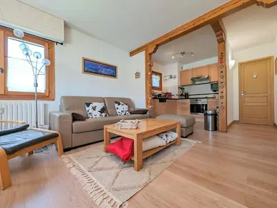 a living room with a couch and a table at Appartement T3 avec 3 balcons et parking, proche centre - FR-1-624-26 in Samoëns