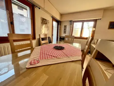 a dining room with a table with a red and white table cloth at Appartement T3 avec 3 balcons et parking, proche centre - FR-1-624-26 in Samoëns