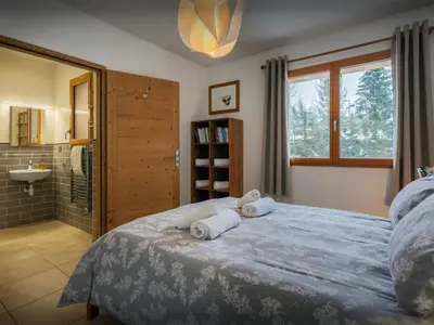 a bedroom with a large bed with towels on it at Chalet Nordchamp - OVO Network in Samoëns