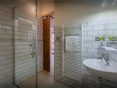 a bathroom with a sink and a glass shower at Chalet Nordchamp - OVO Network in Samoëns