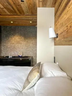 a bedroom with a white bed with a lamp at My Way Megeve village 5 rues parking in Megève