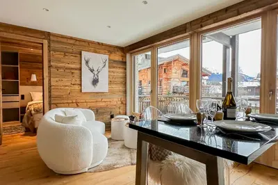 a kitchen with a table and chairs and a window at My Way Megeve village 5 rues parking in Megève