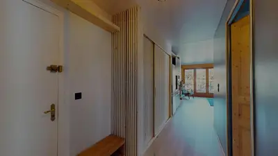 a hallway of a house with a door and a hallway at Bright, warm 2BR 2min to gondola, private garden in Chamonix-Mont-Blanc