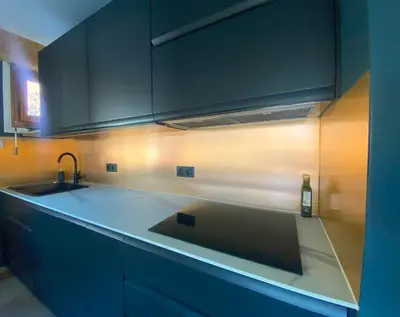 a kitchen with a sink and a counter top at Bright, warm 2BR 2min to gondola, private garden in Chamonix-Mont-Blanc