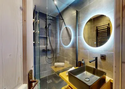 a bathroom with a sink and a shower and a mirror at Bright, warm 2BR 2min to gondola, private garden in Chamonix-Mont-Blanc