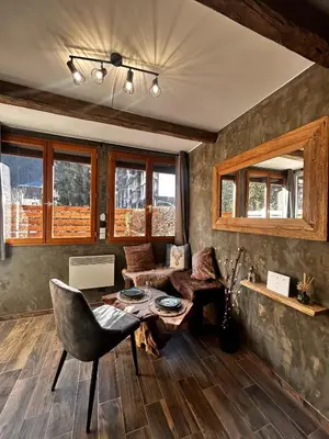 a living room with a couch and a table at Jonquille 2 - Centre - Terrasse Privee - Vues in Chamonix-Mont-Blanc