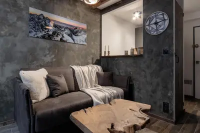 a living room with a couch and a table at Jonquille 2 - Centre - Terrasse Privee - Vues in Chamonix-Mont-Blanc