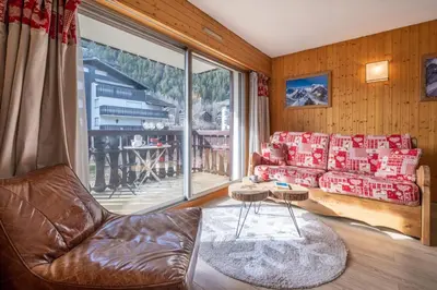 a living room with a couch and a large window at Beautiful 50m with 2 balconies and mountain view in Chamonix-Mont-Blanc