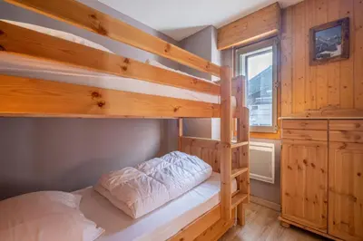 a bedroom with two bunk beds and a window at Beautiful 50m with 2 balconies and mountain view in Chamonix-Mont-Blanc