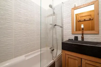 a bathroom with a glass shower and a sink at Beautiful 50m with 2 balconies and mountain view in Chamonix-Mont-Blanc