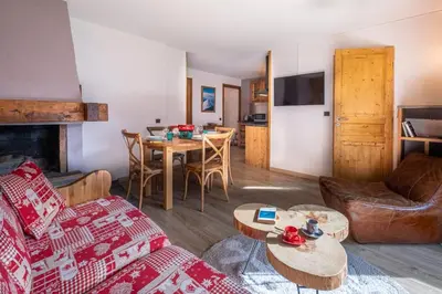 a living room with a couch and a table at Beautiful 50m with 2 balconies and mountain view in Chamonix-Mont-Blanc