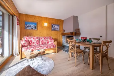 a living room with a couch and a table at Beautiful 50m with 2 balconies and mountain view in Chamonix-Mont-Blanc