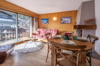 a living room with a table and a couch at Beautiful 50m with 2 balconies and mountain view in Chamonix-Mont-Blanc