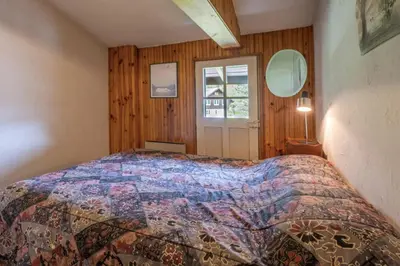 a bedroom with a bed in a room with a window at Cozy big Chalet with Spectacular Mont-Blanc View in Chamonix-Mont-Blanc