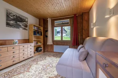 a bedroom with a bed and a window at Cozy big Chalet with Spectacular Mont-Blanc View in Chamonix-Mont-Blanc