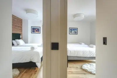 two beds in a room with two beds at Apartment Aiguille Rose in Les Houches