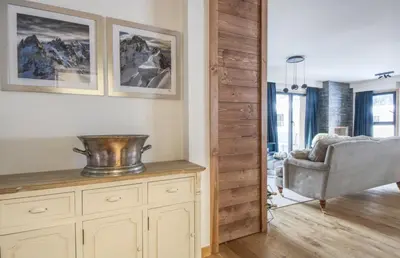 a living room with a chair and a bowl on a cabinet at Apartment Aiguille Rose in Les Houches