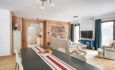 a living room with a table with a bowl of fruit on it at Apartment Aiguille Rose in Les Houches