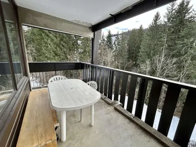 a white table and chairs on a balcony with a view at Appartement 2 Pièces + Coin Nuit, 4-6 Couchages avec Balcon et Parking à Megève - FR-1-597-191 in Megève