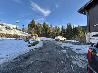a car parked in a driveway in the snow at Appartement 2 Pièces + Coin Nuit, 4-6 Couchages avec Balcon et Parking à Megève - FR-1-597-191 in Megève