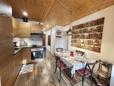 a kitchen with a table and chairs in a room at Appartement 2 Pièces + Coin Nuit, 4-6 Couchages avec Balcon et Parking à Megève - FR-1-597-191 in Megève