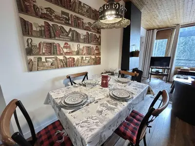 a dining room with a table and a chandelier at Appartement 2 Pièces + Coin Nuit, 4-6 Couchages avec Balcon et Parking à Megève - FR-1-597-191 in Megève