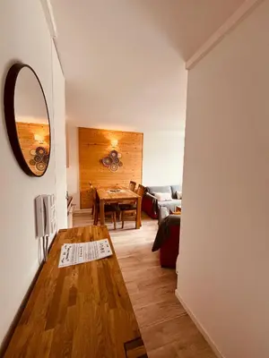 a living room with a table and a couch at appartement petite ourse flaine 2chambres avec wifi in Flaine
