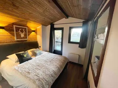 a bedroom with a large bed in a room at Duplex départ randonnée Megeve in Demi-Quartier