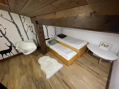 a small room with a bed and a chair at Duplex départ randonnée Megeve in Demi-Quartier