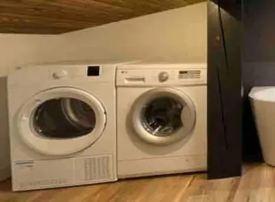 two washing machines sitting next to each other in a room at Duplex départ randonnée Megeve in Demi-Quartier