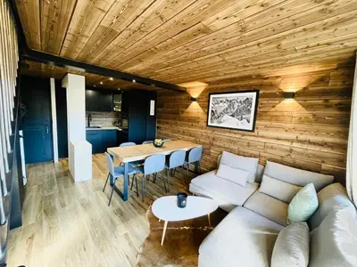 a living room with a couch and a table at Duplex départ randonnée Megeve in Demi-Quartier