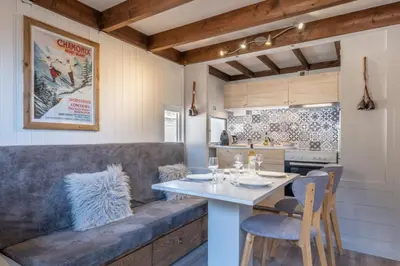 a kitchen with a couch and a table with chairs at Beautiful Apt near the Grands Montets slopes in Chamonix-Mont-Blanc