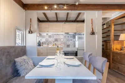 a dining room with a white table and chairs at Beautiful Apt near the Grands Montets slopes in Chamonix-Mont-Blanc
