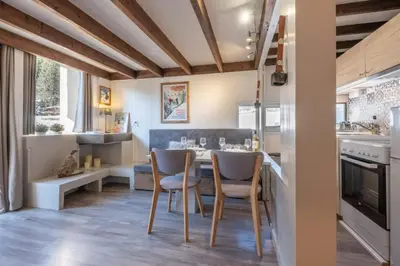 a kitchen with a table and chairs in a room at Beautiful Apt near the Grands Montets slopes in Chamonix-Mont-Blanc