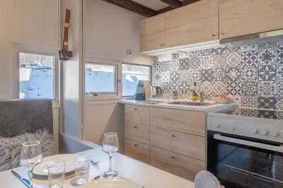 a kitchen with a table with wine glasses on it at Beautiful Apt near the Grands Montets slopes in Chamonix-Mont-Blanc