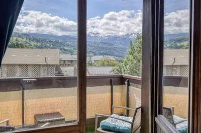 a view from a window of a balcony with mountains at Appartement Cosy - 1 à 2 chambres proche thermes et ski in Saint-Gervais-les-Bains