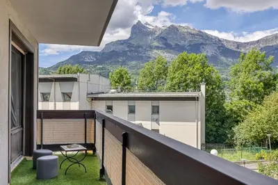 a balcony with a view of a mountain at Appartement Cosy - 1 à 2 chambres proche thermes et ski in Saint-Gervais-les-Bains