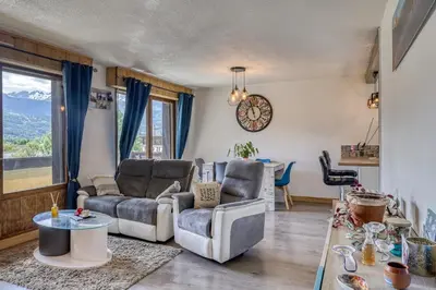 a living room with two couches and a table at Appartement Cosy - 1 à 2 chambres proche thermes et ski in Saint-Gervais-les-Bains