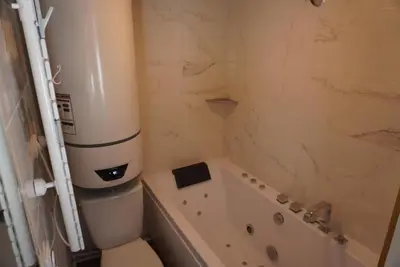 a bathroom with a toilet and a bath tub at Jungle room au centre des Carroz in Les Carroz d'Araches
