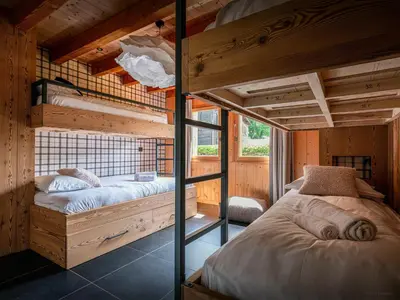 a bedroom with two bunk beds in a cabin at Chalet OCimes - OVO Network in Samoëns