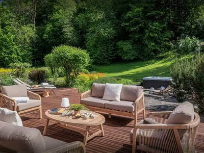 a patio with couches and a table and chairs at Chalet OCimes - OVO Network in Samoëns