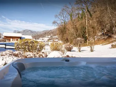 a jacuzzi tub in a snow covered yard at Chalet OCimes - OVO Network in Samoëns