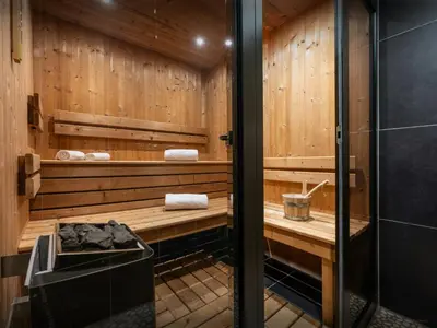 a bathroom with a sauna with wooden walls at Chalet OCimes - OVO Network in Samoëns