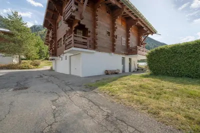 a living room with a red couch and a fireplace at Résidence Améthystes B02 ski in ski out - Happy Rentals in Chamonix-Mont-Blanc