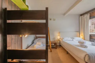 a bedroom with two bunk beds and a couch at Résidence Améthystes B02 ski in ski out - Happy Rentals in Chamonix-Mont-Blanc