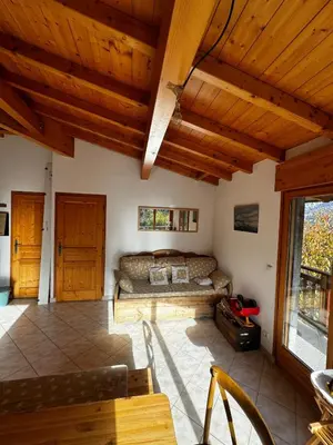 a living room with wooden ceilings and a couch at Appartement Saint-Gervais in Saint-Gervais-les-Bains