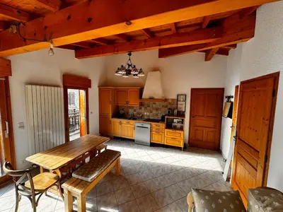 a kitchen with a wooden table and a dining room at Appartement Saint-Gervais in Saint-Gervais-les-Bains
