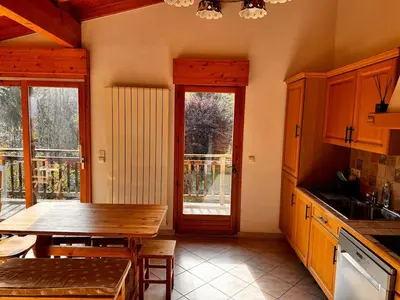 a kitchen with a wooden table and a dining room at Appartement Saint-Gervais in Saint-Gervais-les-Bains