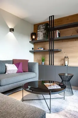 a living room with a couch and a coffee table at Appartement de charme au pied des pistes de Cordon in Cordon