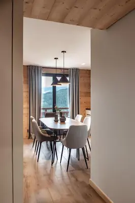 a dining room with a table and chairs at Appartement de charme au pied des pistes de Cordon in Cordon